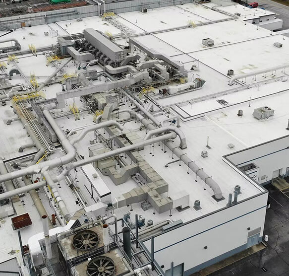 Large industrial facility rooftop showcasing commercial roofing, HVAC, and building envelope infrastructure by RBSG